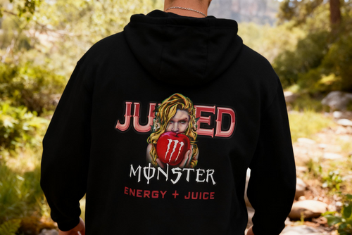 Person wearing a black hoodie with 'Juiced Monster Energy + Juice' design outdoors.